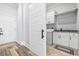 Well-organized laundry room with modern appliances, built-in cabinets, and ample counter space at 1196 Fiddlehead Way, Myrtle Beach, SC 29579