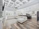 Spacious open-concept living area with a large sectional sofa, an island, and a coffered ceiling at 1196 Fiddlehead Way, Myrtle Beach, SC 29579