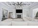 Bright living room with a fireplace, built-in shelving, and views into dining and entry, beneath coffered ceilings at 1196 Fiddlehead Way, Myrtle Beach, SC 29579