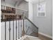 Staircase featuring wood railings, black spindles, and a window at 1196 Fiddlehead Way, Myrtle Beach, SC 29579