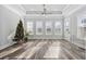 Bright sun room with large windows, stylish flooring, and a decorative Christmas tree at 1196 Fiddlehead Way, Myrtle Beach, SC 29579
