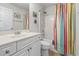 Bright bathroom with a modern vanity, neutral paint, and shower-tub combo with striped curtain at 138 Butkus Dr. # 2, Myrtle Beach, SC 29588