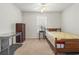 A well-lit bedroom features a wooden bed frame, neutral walls, and a view of the outdoor scenery at 138 Butkus Dr. # 2, Myrtle Beach, SC 29588
