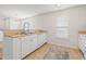 Open kitchen with island, white appliances, and a view to the dining room area at 138 Butkus Dr. # 2, Myrtle Beach, SC 29588