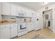 Modern kitchen featuring white appliances, tile flooring, and counter space at 138 Butkus Dr. # 2, Myrtle Beach, SC 29588