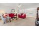 Spacious living room with neutral carpet, ceiling fan, and red sofas at 138 Butkus Dr. # 2, Myrtle Beach, SC 29588