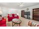 Open living room with red sofas, a glass coffee table, and built-in bookshelves at 138 Butkus Dr. # 2, Myrtle Beach, SC 29588