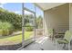 A cozy screened patio with seating and views of the natural landscape for relaxation at 138 Butkus Dr. # 2, Myrtle Beach, SC 29588