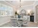 Elegant dining room featuring a modern chandelier, a glass table, and stylish decor at 141 Ranch Haven Dr., Murrells Inlet, SC 29576
