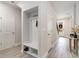 Welcoming entryway with a built-in bench and coat rack, leading to the staircase and front door at 141 Ranch Haven Dr., Murrells Inlet, SC 29576