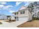 Two story home featuring a two car garage and long driveway with a trimmed lawn at 141 Ranch Haven Dr., Murrells Inlet, SC 29576
