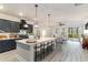 Open concept kitchen with bar stool seating, modern backsplash, and seamless access to the living room at 141 Ranch Haven Dr., Murrells Inlet, SC 29576