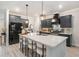 Modern kitchen features an island with white countertop and seating, pendant lights, and stainless steel appliances at 141 Ranch Haven Dr., Murrells Inlet, SC 29576