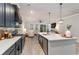 Open kitchen featuring modern appliances, dark cabinets, and a large island with view into the living area at 141 Ranch Haven Dr., Murrells Inlet, SC 29576