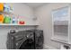 Laundry room featuring modern washer and dryer, wire rack shelving, and a bright window at 141 Ranch Haven Dr., Murrells Inlet, SC 29576