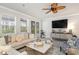 Bright living area with a ceiling fan, large television, and sliding glass door leading to the outdoor area at 141 Ranch Haven Dr., Murrells Inlet, SC 29576