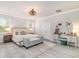 Bright and airy main bedroom features a large bed, vanity area, and elegant chandelier at 141 Ranch Haven Dr., Murrells Inlet, SC 29576