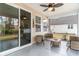 Relaxing screened-in patio with cozy seating and a ceiling fan, perfect for outdoor enjoyment at 141 Ranch Haven Dr., Murrells Inlet, SC 29576