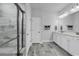 Well-lit bathroom featuring double sinks with a tiled walk-in shower and decorative tile flooring at 1463 Villena Dr., Myrtle Beach, SC 29579