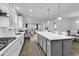 Modern kitchen with white cabinets, spacious island, and seamless flow into the living area at 1463 Villena Dr., Myrtle Beach, SC 29579