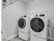 Practical laundry room featuring full size washer and dryer and wire shelving at 1463 Villena Dr., Myrtle Beach, SC 29579