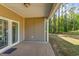 Covered back porch with view of the wooded backyard and sliding glass door access to the home at 1800 Wood Stork Dr., Conway, SC 29526