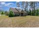 Expansive backyard featuring a well-maintained lawn and views of the house's back patio at 1800 Wood Stork Dr., Conway, SC 29526