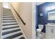 Hallway with stairs next to half bathroom that features a marble top sink and vanity at 1800 Wood Stork Dr., Conway, SC 29526