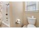 Bathroom with toilet, shower and bath combo and a window providing light at 1800 Wood Stork Dr., Conway, SC 29526