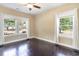 Bright bedroom with hardwood floors and two windows providing a view to the outside at 1800 Wood Stork Dr., Conway, SC 29526