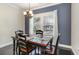 Cozy dining area with a dark wood table, modern lighting, and natural light from the window at 1800 Wood Stork Dr., Conway, SC 29526
