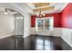 Elegant dining room with hardwood floors, decorative chandelier, and bright window at 1800 Wood Stork Dr., Conway, SC 29526