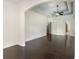Open living room with hardwood floors, white trim, ceiling fan and archway at 1800 Wood Stork Dr., Conway, SC 29526