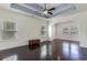 Spacious living room with dark hardwood floors, tray ceiling, and plenty of natural light at 1800 Wood Stork Dr., Conway, SC 29526