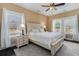 Comfortable main bedroom with a ceiling fan, bedside tables, and lots of natural light at 1800 Wood Stork Dr., Conway, SC 29526
