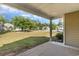 Cozy covered patio offering a relaxed space with a scenic view of the well-manicured front yard at 1800 Wood Stork Dr., Conway, SC 29526