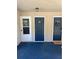 Condo complex entrance with blue door with wreath and carpeted landing at 1870 Auburn Ln. # 21 E, Surfside Beach, SC 29575