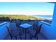Balcony with patio furniture overlooking lush foliage and the beautiful blue ocean at 201 77Th Ave. N # 828, Myrtle Beach, SC 29572
