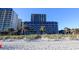 Beachfront resort featuring multiple floors, lawns, sand dunes, and palm trees at 201 77Th Ave. N # 828, Myrtle Beach, SC 29572