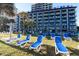 Relaxing resort featuring multiple floors, lawn, palm trees and many lounge chairs at 201 77Th Ave. N # 828, Myrtle Beach, SC 29572