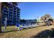 Exterior of a building with well-maintained grounds with lawn chairs and palm trees at 201 77Th Ave. N # 828, Myrtle Beach, SC 29572