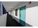 Well-lit hallway with a series of doors and windows, leading to individual units in a modern complex at 201 77Th Ave. N # 828, Myrtle Beach, SC 29572