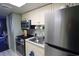 Efficient kitchen featuring modern appliances, white cabinetry, and a tiled backsplash at 201 77Th Ave. N # 828, Myrtle Beach, SC 29572