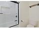 Sleek bathroom showcasing a white toilet, marble tiled shower, and built-in shampoo niche at 205 Double Eagle Dr. # C-2, Myrtle Beach, SC 29575