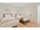 Bright bedroom with two beds, stylish headboards, wood floors, and a white door at 205 Double Eagle Dr. # C-2, Myrtle Beach, SC 29575