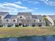 Exterior showcasing multi-level condos with patios, a well-maintained lawn, and waterfront views at 205 Double Eagle Dr. # C-2, Myrtle Beach, SC 29575