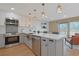 Modern kitchen with stainless steel appliances, white cabinets, a stylish backsplash, and an island at 205 Double Eagle Dr. # C-2, Myrtle Beach, SC 29575