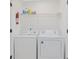 Functional laundry area featuring a washer, a dryer, and storage space for detergents at 205 Double Eagle Dr. # C-2, Myrtle Beach, SC 29575
