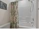 Bright bathroom featuring a tub with white tile surround and a decorative shower curtain at 2090 Cross Gate Blvd. # 205, Surfside Beach, SC 29575