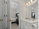 Bathroom featuring white vanity, updated fixtures, and a door leading to the bedroom at 2090 Cross Gate Blvd. # 205, Surfside Beach, SC 29575